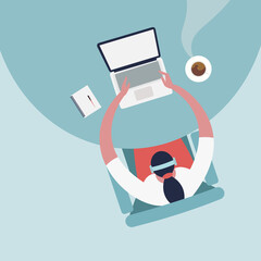 Top view of a woman working on her laptop with steaming coffee on the table