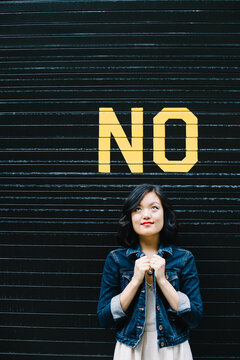 Woman looking up at No sign