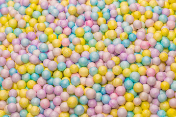 Purple, yellow, blue plastic balls.