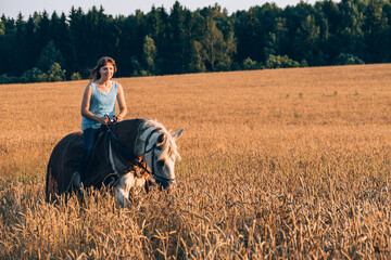 Young woman riding a horse