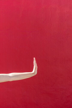 Famale hand against red wall