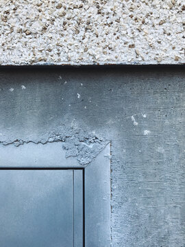 Detail of modern building wall with stucco and metal framing