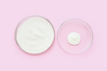 Collagen white powder. Pastel color background. Health product. Woman cosmetics concept. Sport supplement. Skincare cosmetics. Pink monochrome. Cream smear