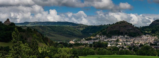  Panoramic  view of Murat , beautiful village in the French region of Cantal with staue of the virgin mary .