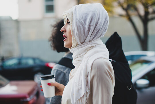 Young Muslim woman walking in the city