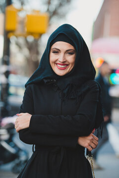 Portrait of smiling Muslim woman in the city