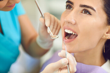 Dental treatment in the clinic. Dentist treats teeth to a young girl in the office of a dental clinic