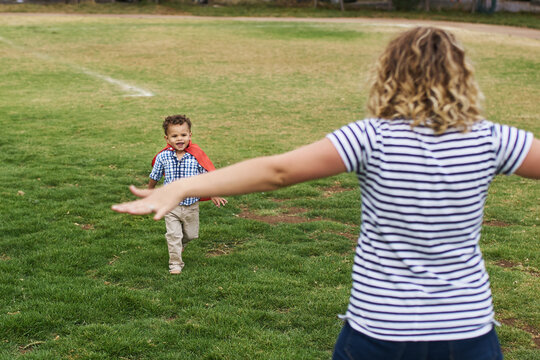 Young mom and her son playing outdoors