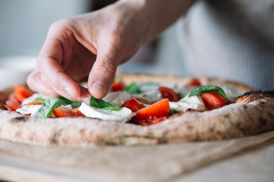 Woman cooking homemade pizza