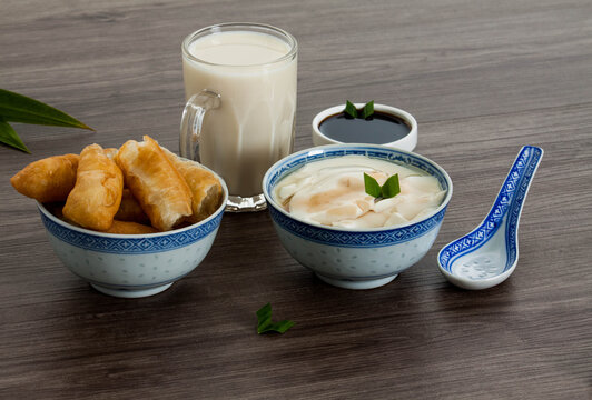 bowl of bean curd or soy pudding with fried dough and soy milk with dark brown sugar