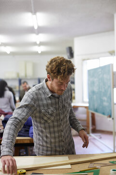 Male student working with an engineering exercise in the classroom