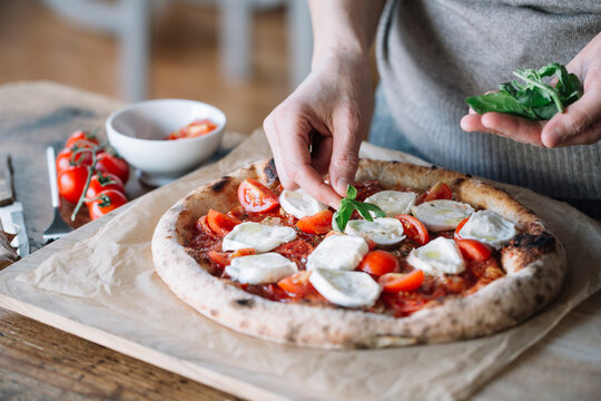 Woman cooking homemade pizza