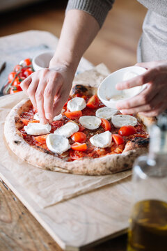 Woman cooking homemade pizza