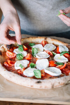 Woman cooking homemade pizza