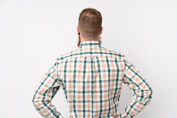 Redhead man with long beard over isolated white background in back position