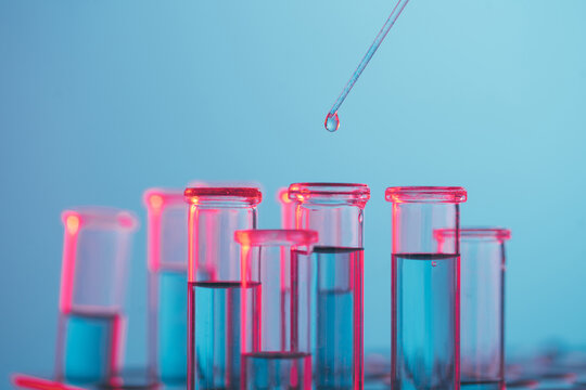 Dropper dropping liquid into test tube.