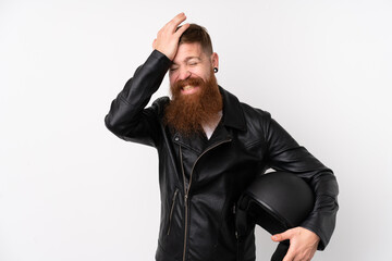 Naklejka premium Redhead man with long beard holding a motorcycle helmet over isolated white background having doubts with confuse face expression