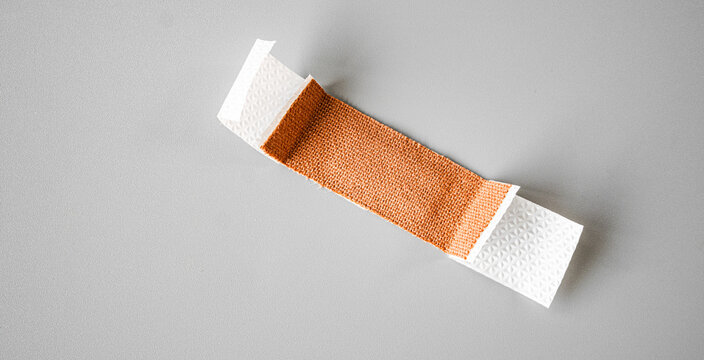 First aid plaster isolated on gray background. A medical equipment bandage.