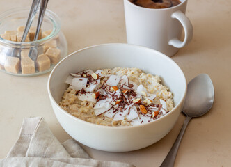 Oatmeal porridge with almonds, coconut and chocolate. Healthy eating. Vegetarian food. Breakfast. Diet.