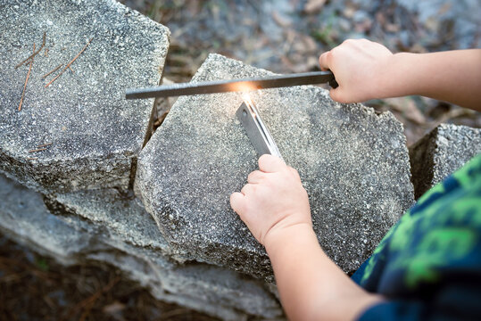 A Child Learns To Start A Campfire