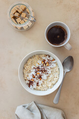 Oatmeal porridge with almonds, coconut and chocolate. Healthy eating. Vegetarian food. Breakfast. Diet.