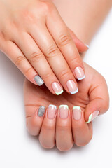 Fototapeta premium French manicure, silver sequins. Blue, mint. Gel design on short square nails close-up on a white background.
