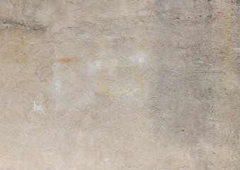 Finely textured concrete wall in shades of tan and grey, creative urban copy space, horizontal aspect