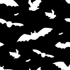 Seamless pattern with flying bats silhouettes. Halloween design on black background.
