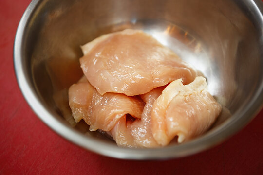 Raw chicken meat prepared for cooking.Fresh uncooked pultry breast cut into pieces for frying in restaurant kitchen.Natural food ingredient with high protein and low fats for healthy eating