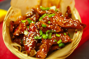 Tasty natural poultry stripes cooked in hot oil.Delicious chicken strips fried in soy sauce for dinner in Asian fast food restaurant