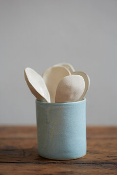 Set of ceramic spoons in a blue mug
