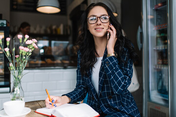 Busy female working remotely in pub