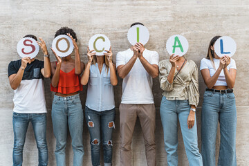 Group of young people from different countries people hiding their faces together with with the...