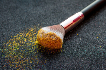 glitter for makeup. Loose gold glitter on the brush for makeup.