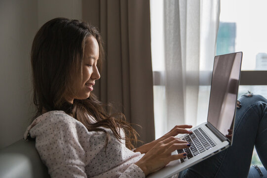 Woman working on her laptop from home