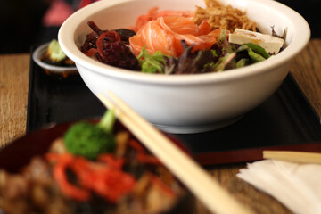Close up of a bowl of raw salmon and vegetable salad, Japanese cuisine