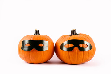 Close up shot of two classic orange pumpkin isolated on bright background as a symbol of autumnal holidays with a lot of copy space for text.