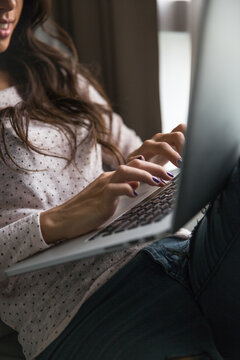 Woman working on her laptop from home