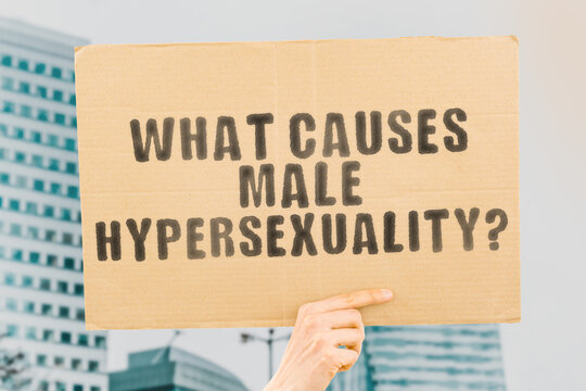 The question " What causes male hypersexuality? " on a banner in men's hand with blurred background. Sex addiction. Passion. Love. Intercourse. Partner 