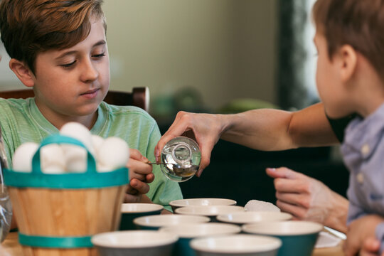 Easter: Boy Measures Vinegar To Add To Dye