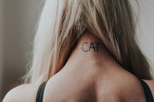 Close up of a tattoo on a blonde woman's neck