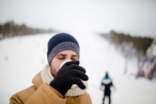 Young man drinking mulled wine