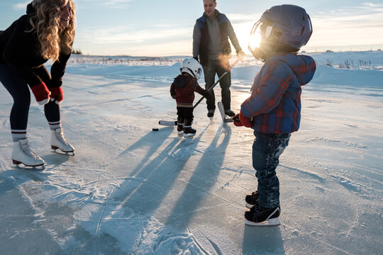 Sun beams through the face mask of a young boy skating with his family