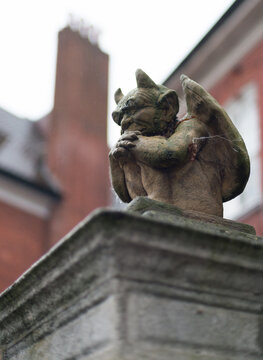 Gargoyle isolated on cloudy background