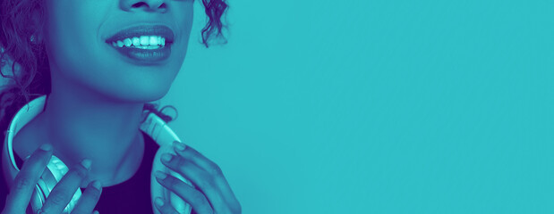 Music listening. Close up portrait of african woman isolated on studio background. Modern and...