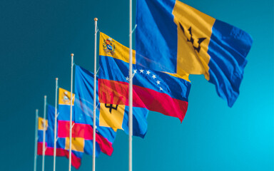 Waving flags of Venezuela and Barbados Island. A symbol of political and economic relations. Partnership and competition on the world