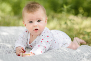 Cute funny 5 month old baby crawling in summer garden