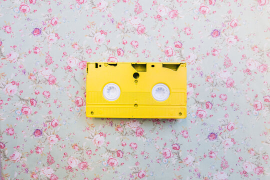yellow vhs record on a floral background