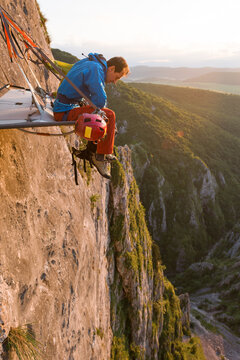 Male alpinist looking down from his portaledge