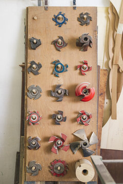 Woodworking Accessories cutters and blades on wooden wall